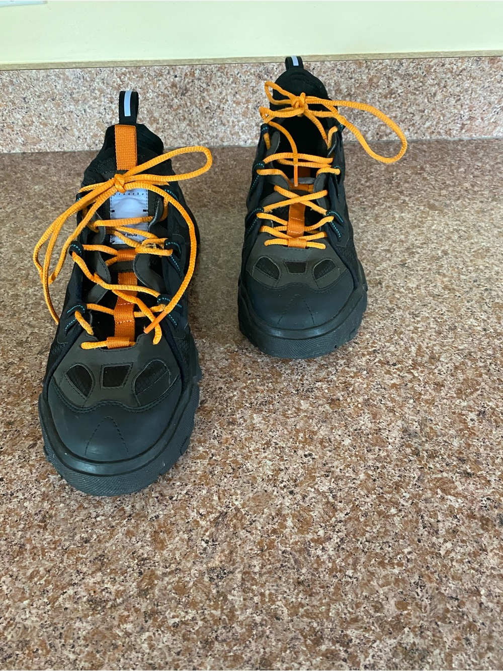 By mcq  orbyt descender black with orange laces